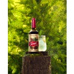 Wild Grove Lemonade on a tree stump with pine cones and leaves.